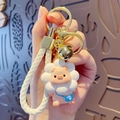 Pink piglet keychain with white flower headpiece and blue crossbody bag charm - Lanyard Style / White
