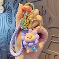 Cute purple sunflower pig keychain with golden ring bell and braided cord accessory - Lanyard Style / Purple