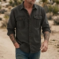 Detail of dark charcoal cotton tactical shirt showing double chest pockets and copper buttons - Black