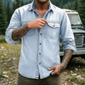 Close-up of men's blue denim shirt showing dual chest pockets and stitching details - Light Blue