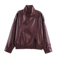 Détail d'une veste vintage en cuir châtain avec épaulettes et texture grainée lychee - XS / Rouge