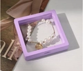 Lavender PE film suspension jewelry box featuring a pearl and gold tube bracelet - 9*9cm / Purple