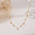 Macro shot of gold-plated titanium necklace featuring five prong-set clear zircon charms - Galaxy Pendant (XKN0253)