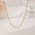 Detail of elegant gold titanium necklace featuring alternating rectangular and round links - Interlocking Rings (XKN0252)