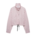 Detail of pink polka dot bomber jacket featuring high stand collar and black drawstring hem - Pink Polka Dot Jacket