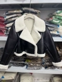 Detail view of the black faux leather jacket featuring white plush shearling fleece lining - XS / Black