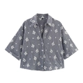 Detail of embroidered floral patterns on black and white gingham checkered shirt - Short Sleeve Shirt