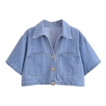 Detailed close-up of light blue washed denim cropped jacket with gold buttons - XS / Tops / Light Blue