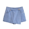 Detail of light blue denim skort featuring asymmetric wrap design and metallic buttons - XS / Bottoms / Light Blue
