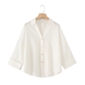Detailed view of linen blend shirt with V-neck collar and natural wooden buttons - White