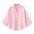 Detail of light pink linen shirt featuring natural wooden buttons and a wide cuff design - Pink