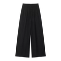 Détail d'un pantalon noir à jambe large avec taille élastique et texture plissée - Pantalon Noir