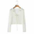 White long-sleeve knit cardigan featuring a V-neck, ribbon tie, and floral appliques - One Size / White