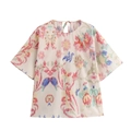 Detail of bohemian floral print on white short sleeve top with back tie-up neck closure - S / Tops