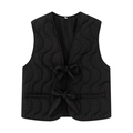 Detailed view of wave quilted black vest featuring front tie-up bows and a sleek V-neckline - S / Black