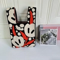 Close-up of contrast floral pattern on a thick knit tote bag with U-shaped handles - Black Tulip