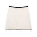 Cream knit mini skirt with black contrast trim shown in a professional flat lay view - Skirts