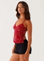 Detail of red sequined camisole with white floral beadwork and thin shoulder straps - S / Red