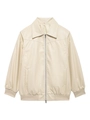 Détail de la veste en cuir PU crème avec fermeture éclair métallique et bords-côtes - Abricot