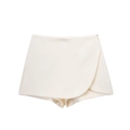 Detalle de falda pantalón beige de cintura alta con cremallera lateral y diseño asimétrico - XS / Blanco lechoso