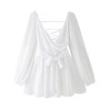 Detail of white V-neck mini dress showing cross back ties and chiffon fabric texture - White