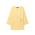 Detail of light yellow linen wrap top showing V-neck and branded label with size S - XS / Tops / Yellow