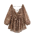 Detail view of leopard print dress featuring V-neck wrap design and waist tie bow - Animal Print