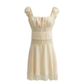 Detail view of cream vintage dress featuring intricate hollow lace trim and puff sleeves - S / Beige