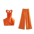 Detail of bright orange halter wrap top and high waist wide leg pants set for summer - XS / Top And Bottom / Orange