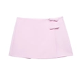 Détail d'une mini-jupe rose clair avec nœuds décoratifs latéraux et fermeture invisible - XS / Bas / Rose