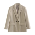 Close-up detail of beige double-breasted blazer showing notch lapels and flap pockets - Off White