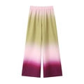 Detail of high-waisted wide-leg pants featuring a vibrant gradient tie-dye pattern and elastic waist - XS / Pants