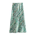 Detailed view of mint green A-line midi skirt with abstract white floral patterns - Green Skirt