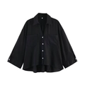 Flat lay of black loose-fit shirt with deep V-neck, chest pockets, and white buttons - Black