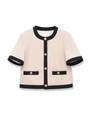 Detail of elegant cream knit cardigan featuring black trim and decorative gold buttons - S / Apricot Top