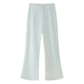 Detailed view of the pleated waist and clean drape of white wide-leg trousers - S / White Pants