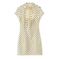 Detailed back view of a beige polka dot mini dress featuring a cutout design and bow tie knot - XS / Yellow Dots