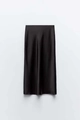 Detailed view of black satin midi skirt featuring smooth glossy fabric and elegant drape - Black