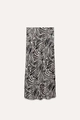 Detailed view of the elegant black and white zebra print on a smooth satin midi skirt - Stripe