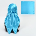 Glossy bright blue satin silk scarf shown as a square layout and tied on hair - Sky Blue