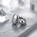 Minimalist silver open geometric ring with pebble and sphere ends on stone surface - One Size / Silver