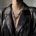 Layered Y2K dark aesthetic silver necklace with star and moon charms on a chic suit - Butterfly Star Moon Tassel Necklace