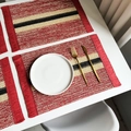 Red woven paper rope placemats with cream and black striped patterns for holiday table decor - Red Striped Woven with Tassels