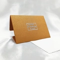 Polished jewelry cleaning cloth kit with elegant gold textured paper case and white cloth - Caramel color