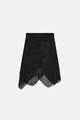 Chic black sparkly knit skirt featuring an asymmetrical scalloped hem and layered mesh detail - S / Black