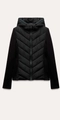 Detailed view of women's black hooded puffer jacket featuring V-shaped quilted design - XS / Black