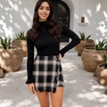 Close-up of black and white plaid shorts with wavy hem, embroidery, and gold buttons - S / Bottoms / Black Gray Plaid