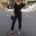 Detail of black cold-shoulder jumpsuit featuring elastic waist and cinched leg cuffs - S / Black