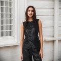 Detail of single-breasted black PU leather vest with round neck and flap pockets - S / Tops / Black
