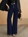 Detail of high-waist navy wide-leg trousers with gold chain belt and vertical pleats - S / Bottoms / Navy Blue